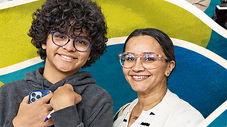A young participant and an adult at Visions of Community